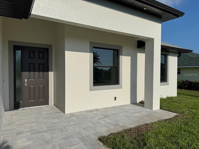 9 Bunker Pl, Rotonda West, FL 33947 - property entrance featuring stucco siding