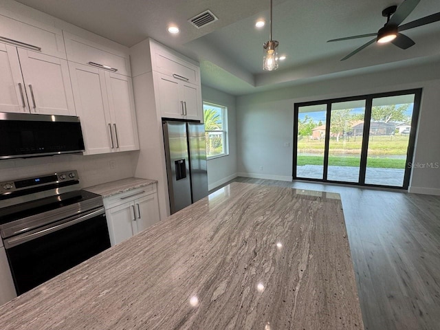 9 Bunker Pl, Rotonda West, FL 33947 - kitchen with appliances with stainless steel finishes, baseboards, open floor plan, plenty of natural light, and recessed lighting