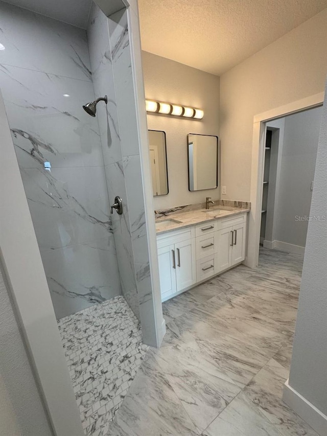 9 Bunker Pl, Rotonda West, FL 33947 - bathroom with marble finish flooring, a marble finish shower, double vanity, a textured ceiling, and baseboards