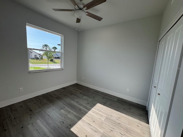 9 Bunker Pl, Rotonda West, FL 33947 - unfurnished bedroom featuring baseboards, wood finished floors, a closet, and ceiling fan