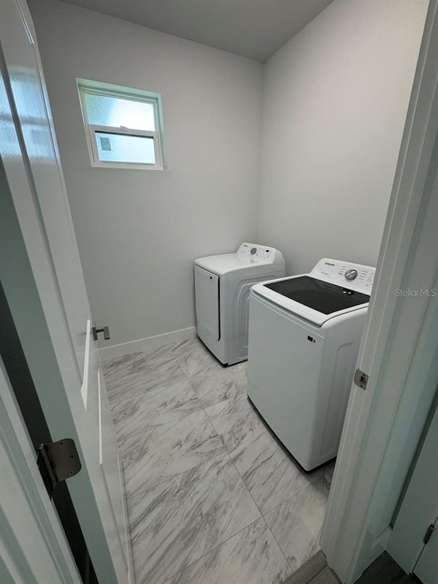 9 Bunker Pl, Rotonda West, FL 33947 - laundry room with washing machine and dryer and light marble finish floors