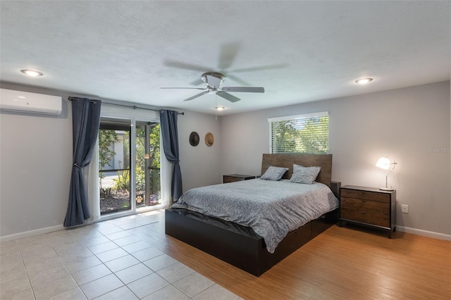 1343 Charlotte St, Altamonte Springs, FL 32701 - bedroom with a wall mounted air conditioner, baseboards, access to outside, a ceiling fan, and light wood-type flooring