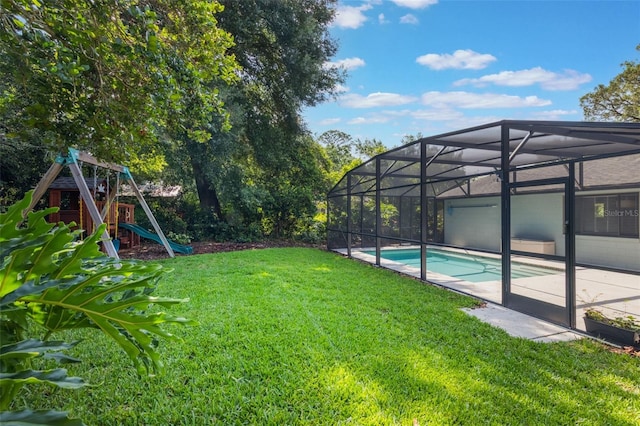 1343 Charlotte St, Altamonte Springs, FL 32701 - view of grassy yard with a playground, an outdoor pool, a patio, and glass enclosure