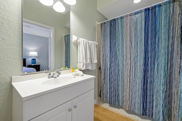 4816 Tidecrest Ave Unit 178, Orlando, FL 32819 - bathroom with a textured wall, vanity, tile patterned floors, ensuite bath, and a shower with shower curtain