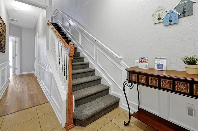 4816 Tidecrest Ave Unit 178, Orlando, FL 32819 - stairs featuring a textured wall and tile patterned floors