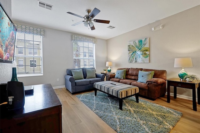 4816 Tidecrest Ave Unit 178, Orlando, FL 32819 - living room with light wood-style floors, a ceiling fan, and baseboards