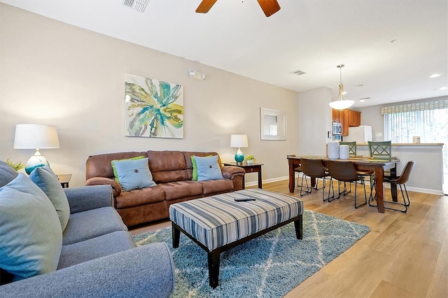4816 Tidecrest Ave Unit 178, Orlando, FL 32819 - living area featuring baseboards, light wood-type flooring, and a ceiling fan