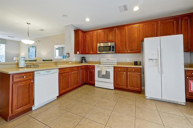 4816 Tidecrest Ave Unit 178, Orlando, FL 32819 - kitchen with white appliances, light countertops, recessed lighting, a peninsula, and decorative light fixtures