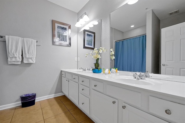 4816 Tidecrest Ave Unit 178, Orlando, FL 32819 - full bathroom with baseboards, double vanity, tile patterned flooring, and curtained shower
