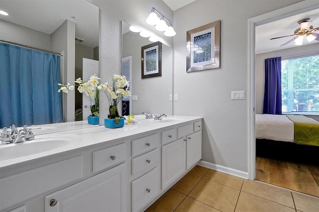 4816 Tidecrest Ave Unit 178, Orlando, FL 32819 - ensuite bathroom with tile patterned flooring, double vanity, baseboards, ceiling fan, and a textured wall