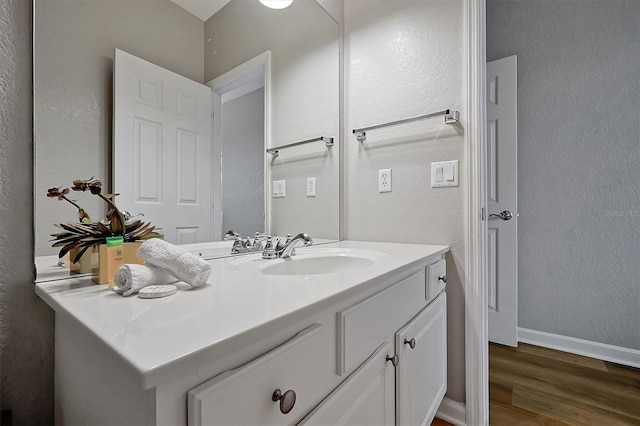 4816 Tidecrest Ave Unit 178, Orlando, FL 32819 - bathroom featuring wood finished floors, vanity, a textured wall, and baseboards