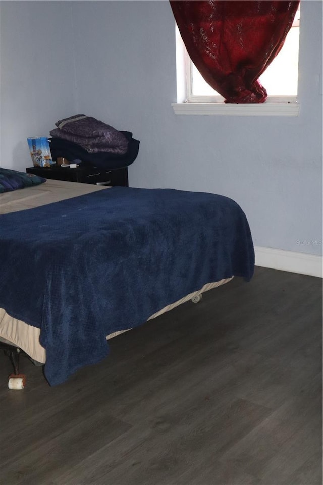 1212 Leon Ln, Daytona Beach, FL 32117 - bedroom with wood finished floors, multiple windows, and baseboards