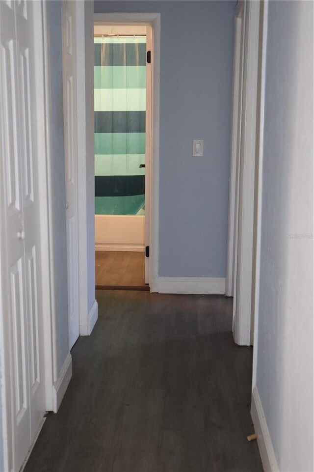 1212 Leon Ln, Daytona Beach, FL 32117 - corridor with baseboards and wood finished floors