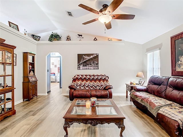 2771 NE 66th St, Ocala, FL 34479 - living room with a ceiling fan, lofted ceiling, light wood finished floors, arched walkways, and baseboards