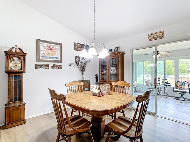 2771 NE 66th St, Ocala, FL 34479 - dining room with light wood-type flooring, vaulted ceiling, a chandelier, and baseboards