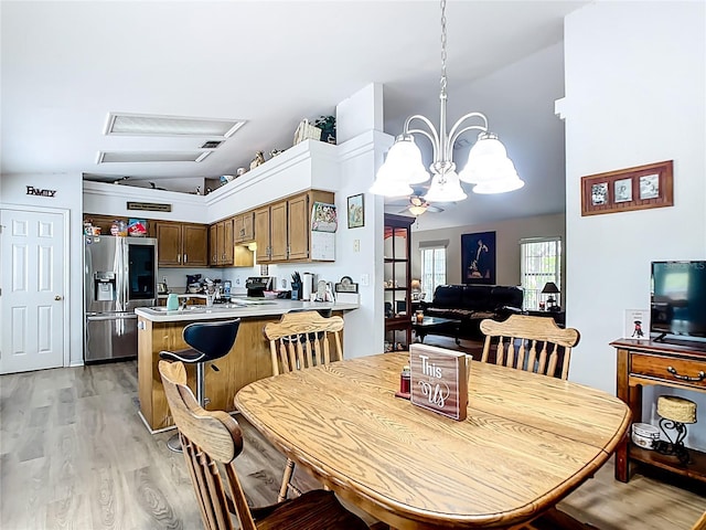 2771 NE 66th St, Ocala, FL 34479 - dining area with light wood-style floors, a chandelier, and vaulted ceiling