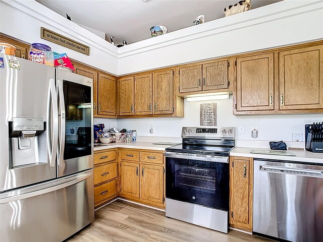 2771 NE 66th St, Ocala, FL 34479 - kitchen featuring stainless steel appliances, light countertops, brown cabinetry, and light wood-style floors