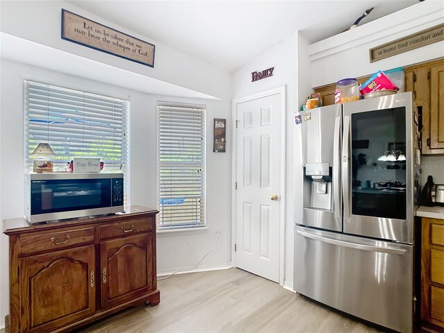 2771 NE 66th St, Ocala, FL 34479 - kitchen featuring appliances with stainless steel finishes, light wood finished floors, and vaulted ceiling