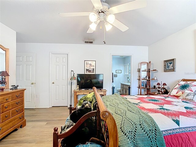 2771 NE 66th St, Ocala, FL 34479 - bedroom with light wood-style floors, ceiling fan, and ensuite bath