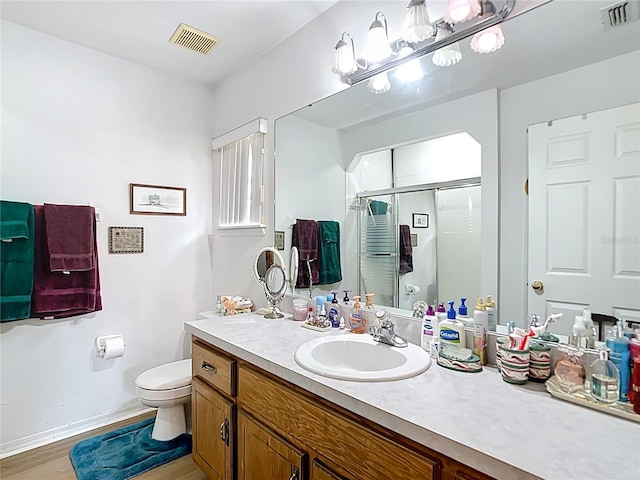 2771 NE 66th St, Ocala, FL 34479 - full bathroom featuring toilet, vanity, a shower stall, baseboards, and wood finished floors