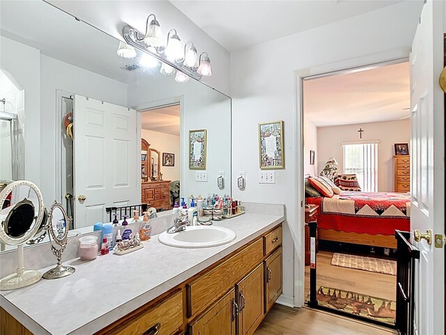 2771 NE 66th St, Ocala, FL 34479 - ensuite bathroom featuring vanity, wood finished floors, and an enclosed shower