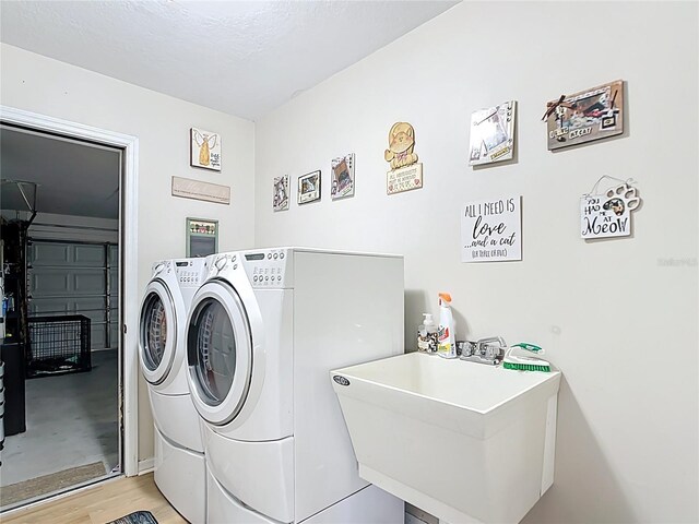 2771 NE 66th St, Ocala, FL 34479 - washroom featuring separate washer and dryer and light wood-style flooring