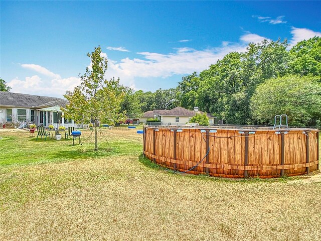 2771 NE 66th St, Ocala, FL 34479 - view of green lawn featuring an outdoor pool