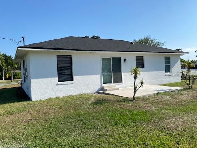 1750 Mitten Ter, Deltona, FL 32738 - rear view of house with stucco siding, a patio area, and a yard