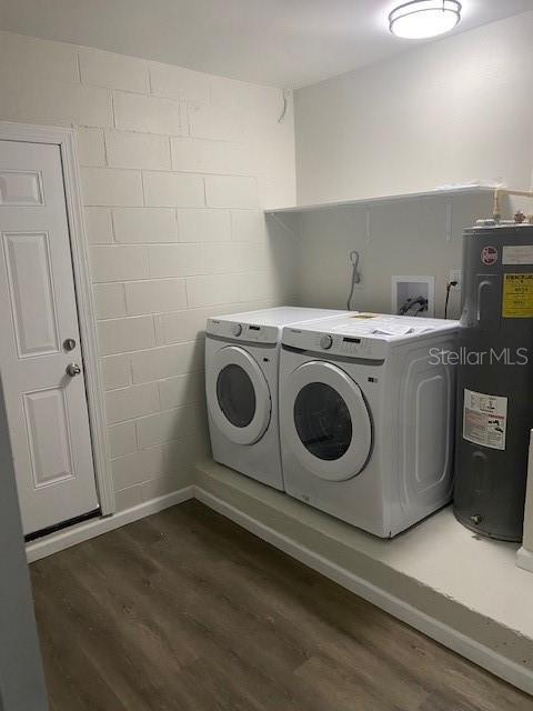 1750 Mitten Ter, Deltona, FL 32738 - washroom featuring washing machine and dryer, electric water heater, and dark wood finished floors