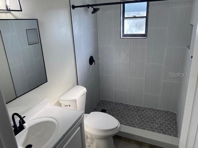 1750 Mitten Ter, Deltona, FL 32738 - bathroom with vanity, a tile shower, and toilet