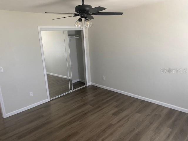 1750 Mitten Ter, Deltona, FL 32738 - unfurnished bedroom with baseboards, dark wood-style floors, a closet, and a ceiling fan