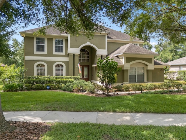490 Wekiva Preserve Dr, Apopka, FL 32712 - mediterranean / spanish home featuring stucco siding, a front yard, and a shingled roof