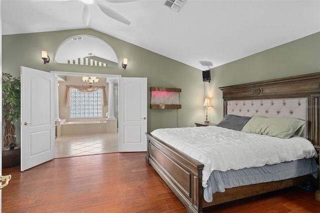 490 Wekiva Preserve Dr, Apopka, FL 32712 - bedroom with vaulted ceiling, wood finished floors, a chandelier, connected bathroom, and a ceiling fan