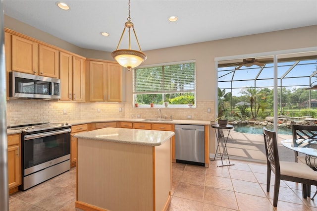 490 Wekiva Preserve Dr, Apopka, FL 32712 - kitchen featuring stainless steel appliances, light brown cabinets, a sink, a center island, and recessed lighting