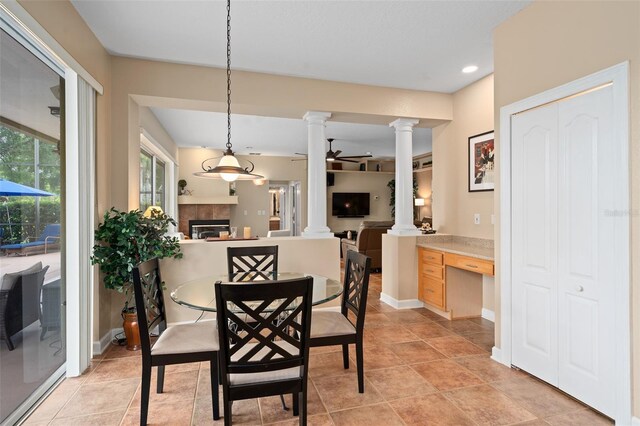 490 Wekiva Preserve Dr, Apopka, FL 32712 - dining area with ornate columns, a tiled fireplace, recessed lighting, and baseboards