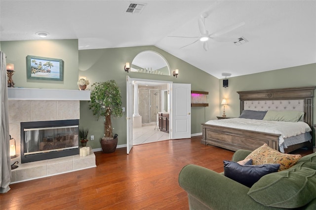 490 Wekiva Preserve Dr, Apopka, FL 32712 - bedroom featuring wood finished floors, vaulted ceiling, a tile fireplace, baseboards, and ensuite bath
