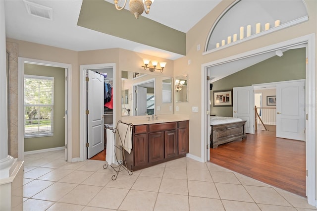 490 Wekiva Preserve Dr, Apopka, FL 32712 - bathroom featuring a chandelier, vanity, tile patterned flooring, a spacious closet, and baseboards