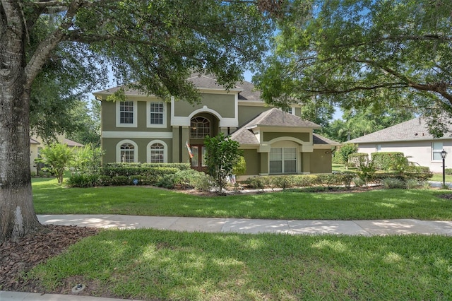 490 Wekiva Preserve Dr, Apopka, FL 32712 - view of front facade with stucco siding, a front yard, and a shingled roof
