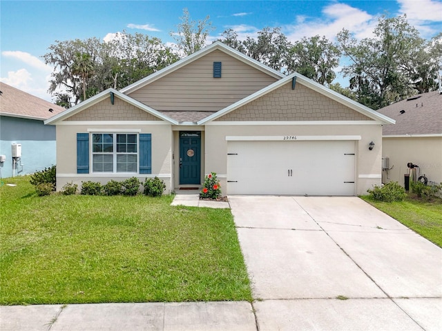 29746 Anahid Dr, Leesburg, FL 34748 - view of front of home featuring a front yard, an attached garage, driveway, and stucco siding