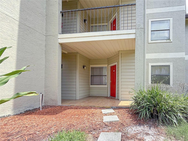 3034 Parkway Blvd Unit 102, Kissimmee, FL 34747 - view of exterior entry featuring a balcony and stucco siding