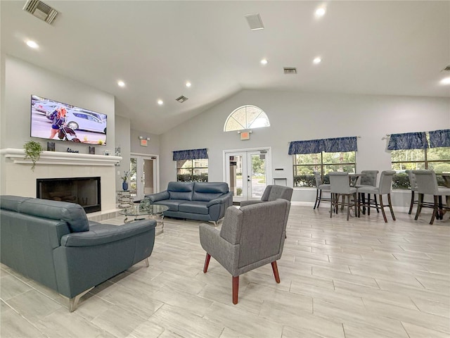 3034 Parkway Blvd Unit 102, Kissimmee, FL 34747 - living area featuring recessed lighting, high vaulted ceiling, french doors, and a tile fireplace