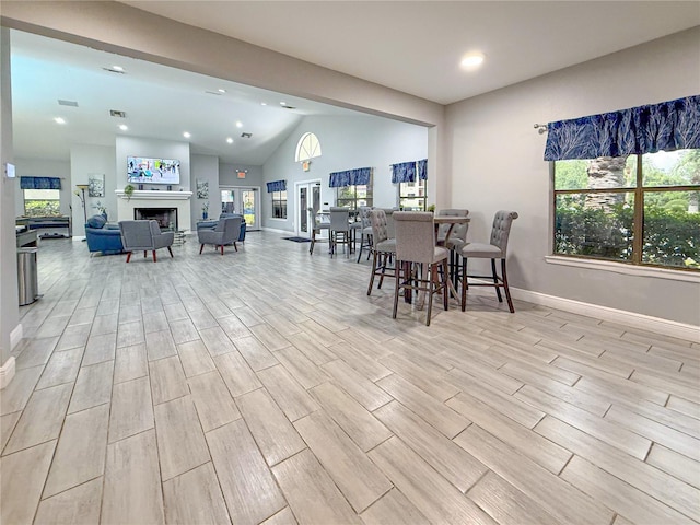 3034 Parkway Blvd Unit 102, Kissimmee, FL 34747 - dining space with recessed lighting, healthy amount of natural light, baseboards, light wood-style flooring, and a fireplace