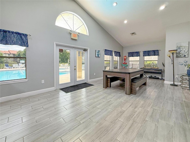 3034 Parkway Blvd Unit 102, Kissimmee, FL 34747 - recreation room with french doors, high vaulted ceiling, baseboards, wood tiled floors, and recessed lighting