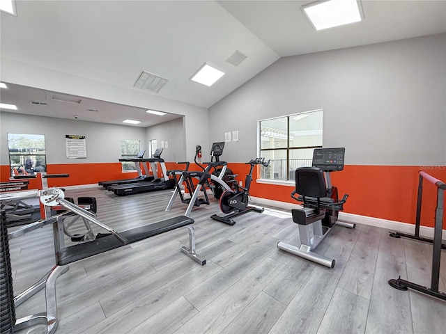3034 Parkway Blvd Unit 102, Kissimmee, FL 34747 - workout area with wood finished floors, vaulted ceiling, and baseboards