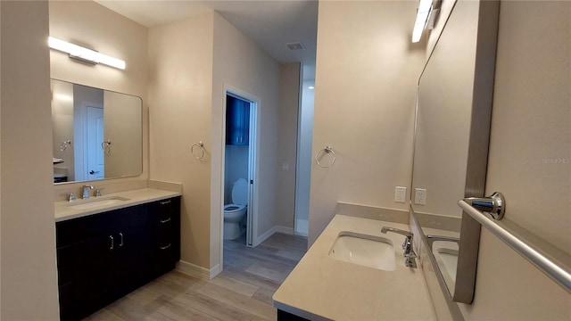 3269 Ponce De Leon Blvd, North Port, FL 34291 - full bath with wood finished floors, vanity, toilet, and baseboards