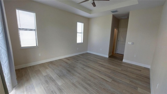 3269 Ponce De Leon Blvd, North Port, FL 34291 - empty room featuring ceiling fan, a tray ceiling, light wood-type flooring, and baseboards
