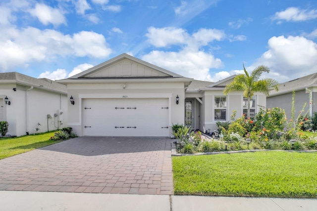 1425 Lone Wood Blvd, Orlando, FL 32828 - ranch-style house with decorative driveway, a front yard, a garage, and stucco siding