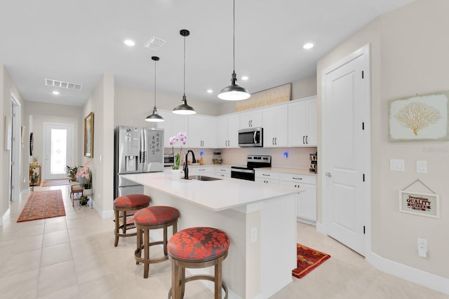 1425 Lone Wood Blvd, Orlando, FL 32828 - kitchen with appliances with stainless steel finishes, a sink, baseboards, a breakfast bar, and decorative backsplash