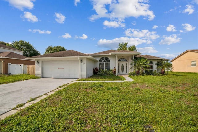 657 Mckinley Ct, Kissimmee, FL 34758 - view of front facade featuring a garage, stucco siding, and concrete driveway