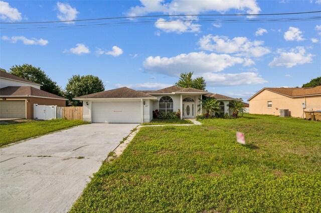 657 Mckinley Ct, Kissimmee, FL 34758 - view of front of property with an attached garage, concrete driveway, stucco siding, and central AC unit